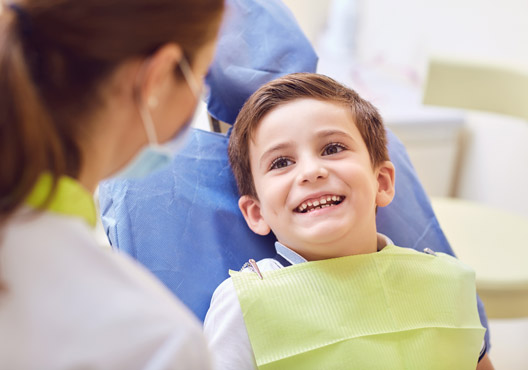 child smiling at dentist